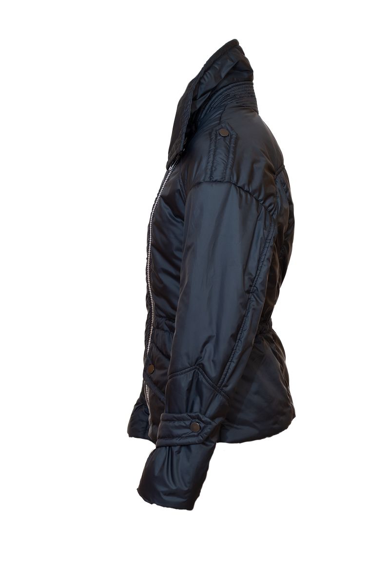 Model wearing Aster alpaca jacket sitting on a patio