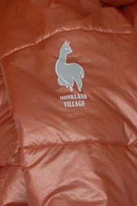 Model wearing Solstice Alpaca insulated puffer jacket on a podium at Montreal Fashion Week runway